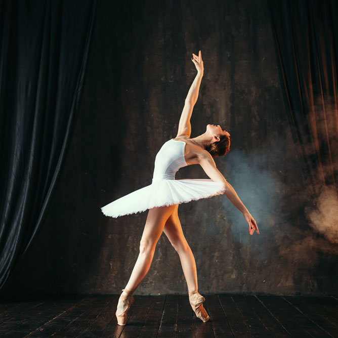 Ballerina in white dress dancing in ballet class